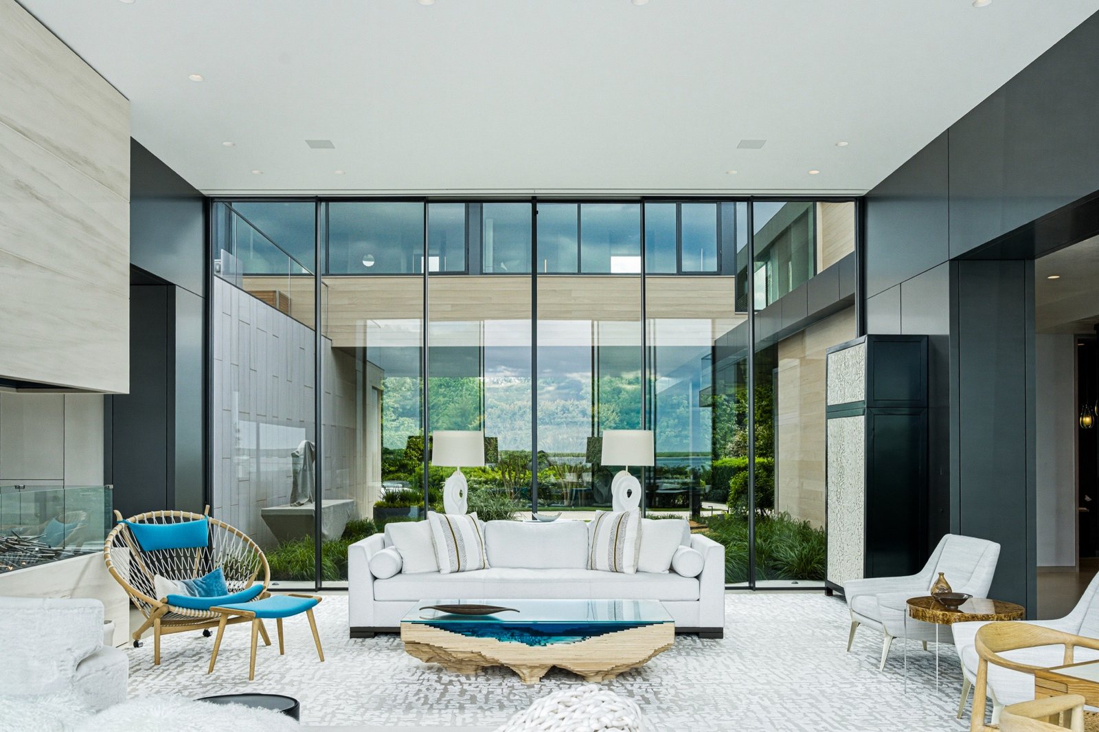 Modern living room with floor-to-ceiling glass overlooking the water